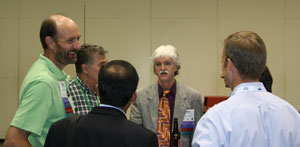 Picture of members of the Labs21 Team chatting with other attendees
