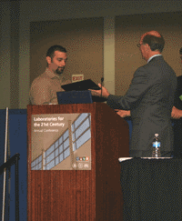 Robert Deluca shakes hands with Joe Phillips as he accepts's Lab Crafters award 