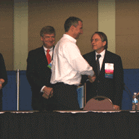 Peter Rumsey shakes hands with Will Lintner, DOE, as he accepts his award 